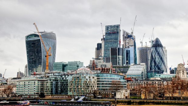 Air quality monitoring of volatile organic compounds with PID-3 | ION SENSE London skyline along the Thames with the Walkie Talkie building on the left, The Gherkin on the right, and construction cranes overhead under a cloudy sky.
