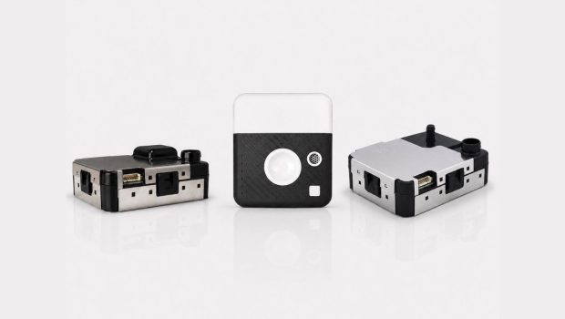 ION SENSE PM Sensors - Press Release | ION SENSE Three small modular electronic devices with metal housings and black panels arranged on a white reflective surface, likely prototype modules or adapters.