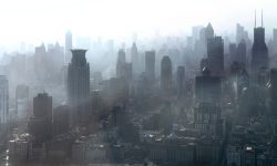Dense city skyline with tall skyscrapers fading into foggy haze.